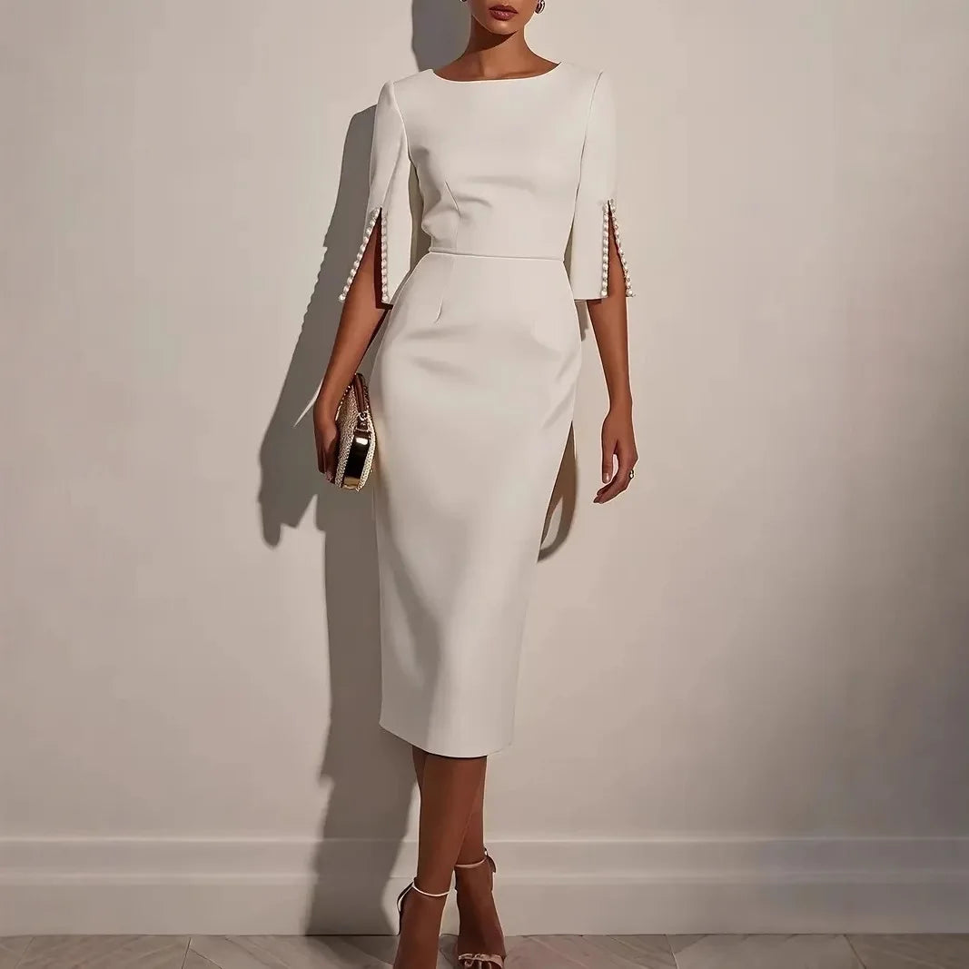 LUCIA - ELEGANTE JURK MET OPEN MOUWEN GERAFFD MET PARELS