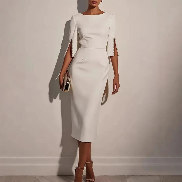 LUCIA - ELEGANTE JURK MET OPEN MOUWEN GERAFFD MET PARELS